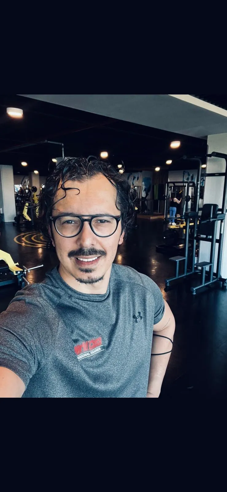 Professional wellness coach demonstrating proper form in a bright, airy studio
