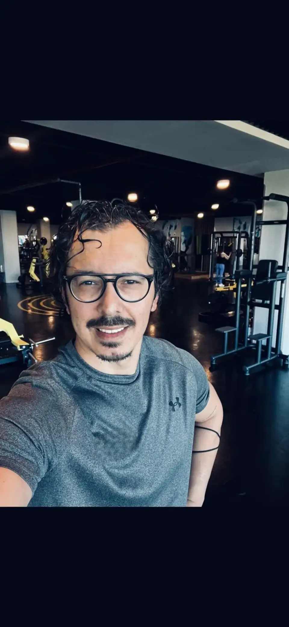 Professional wellness coach demonstrating proper form in a bright, airy studio